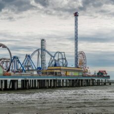 blue and white ferris wheel near body of water during daytime