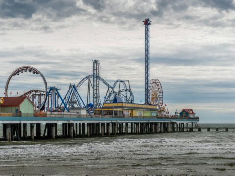 blue and white ferris wheel near body of water during daytime